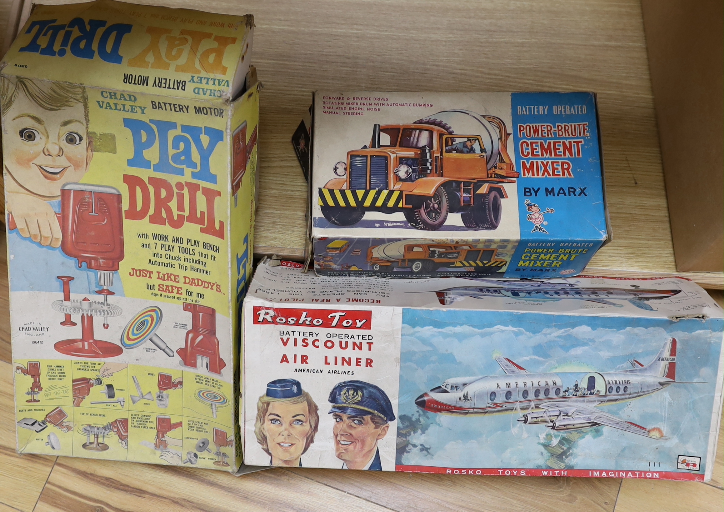 Three boxed 1960s battery operated plastic toys including a Rosho Toy tinplate and plastic airliner, a Marx Power-Brute Cement Mixer and a Chad Valley Play Drill, air liner 45cm long